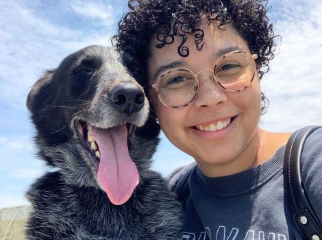 Yogi the dog with is smiling person