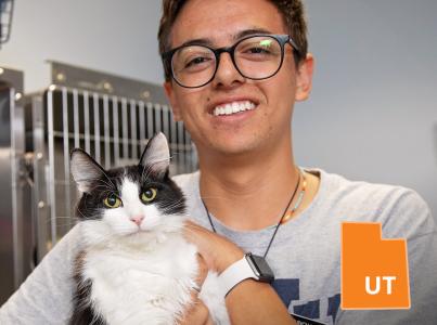 Man holding cat in shelter