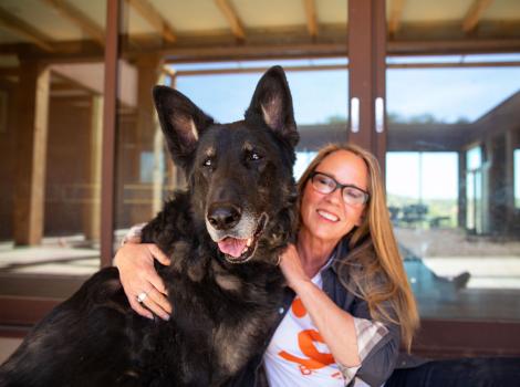 Julie Castle hugging Shadow the dog