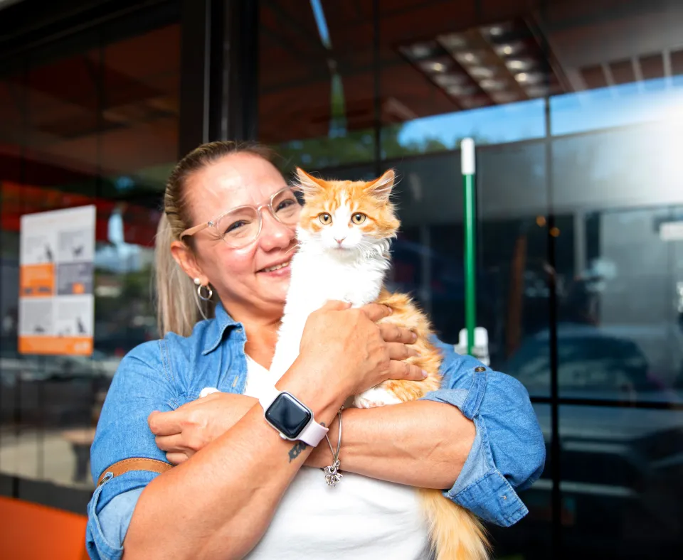 Smiling person holding a newly adopted cat in Salt Lake City