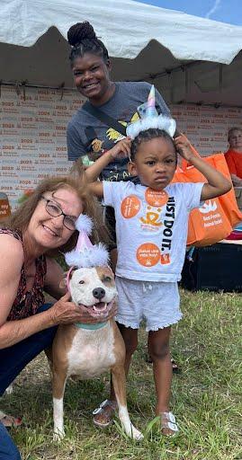 Coral the dog smiling with her new family