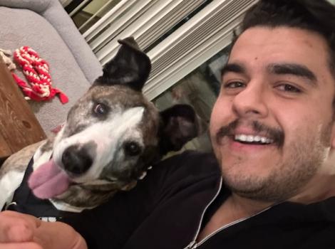 Selfie of Victor with Dakota the dog whose tongue is out