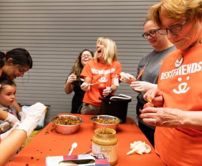 Smiling volunteers making enrichment toys for dogs