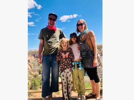 The Williams family outside in Angels Canyon in front of a blue sky