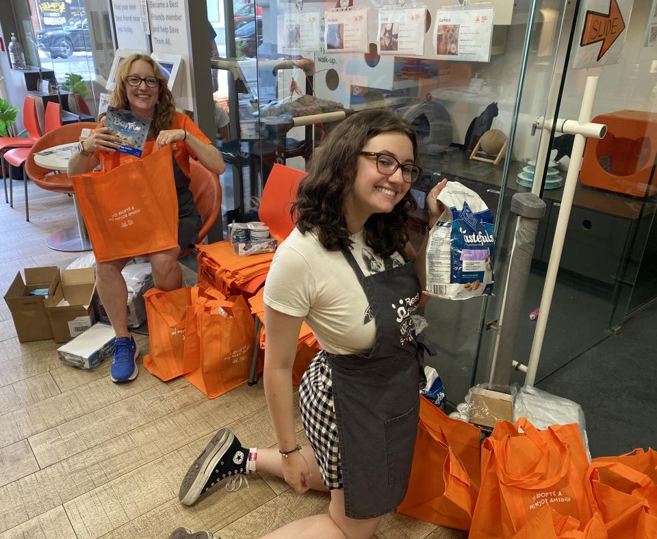 People putting Blue Buffalo pet food into orange Best Friends bags