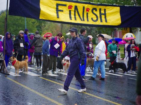 Julie Castle bundled up in warm clothing at the finish line of the first-ever Strut Your Mutt event