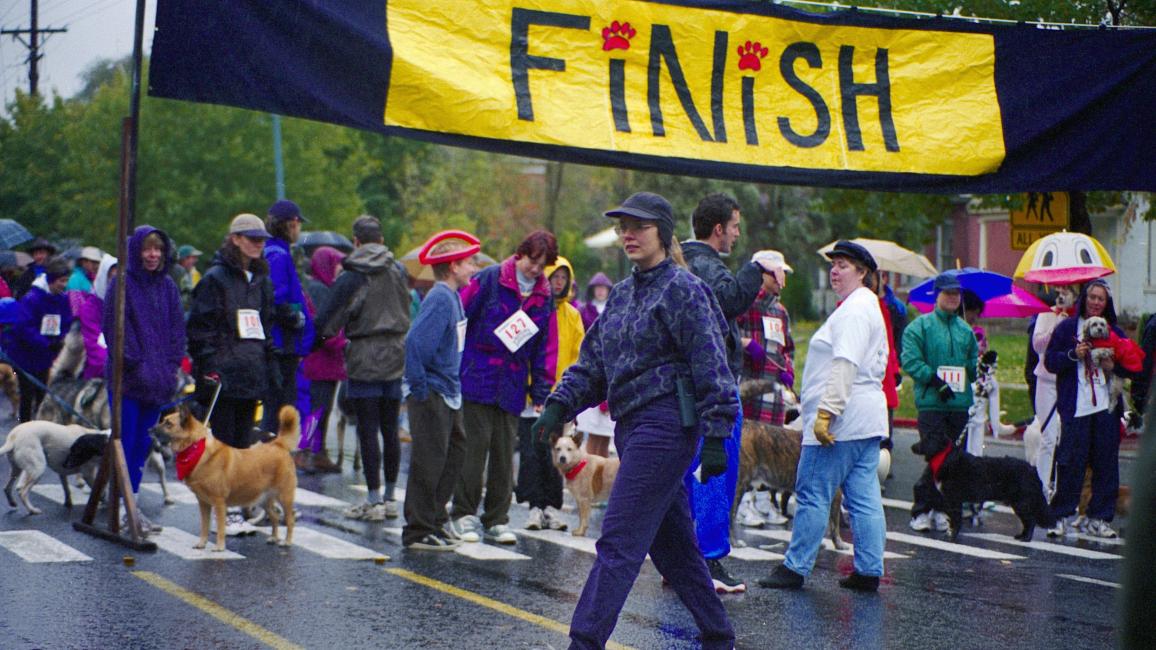 Julie Castle bundled up in warm clothing at the finish line of the first-ever Strut Your Mutt event