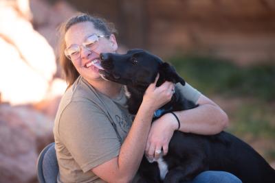 Greggy the dog giving a kiss to Makayla