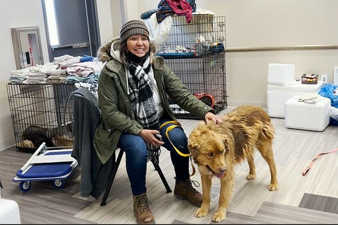 woman from the Navajo Nation waits to get her pet vaccinated