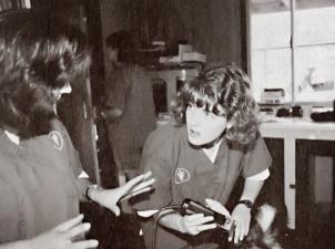 Old clinic photo of woman performing proceedure