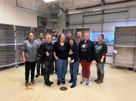 Staff from San Angelo Animal Services standing in front of empty kennels