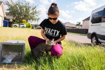 Person with a cat next to a box used to transport the cat back to where she came from