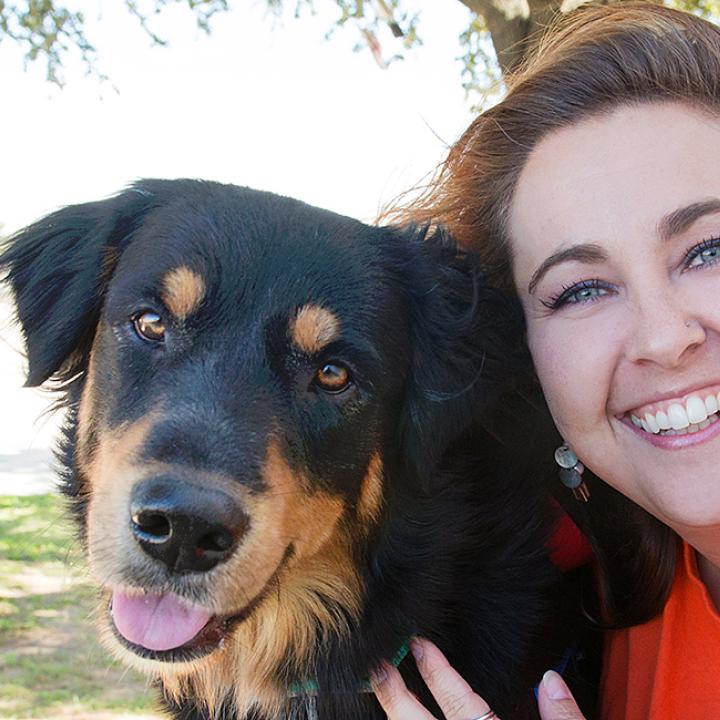 Smiling person outside with a happy looking dog