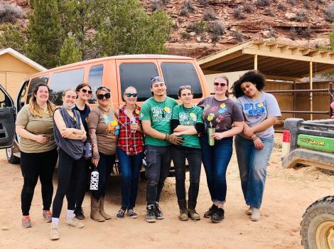 Starbucks volunteers at the Sanctuary outside behind a van