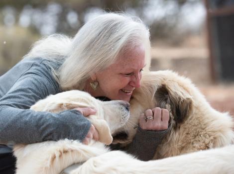 Val Hardin hugging Anna and Racer the dogs