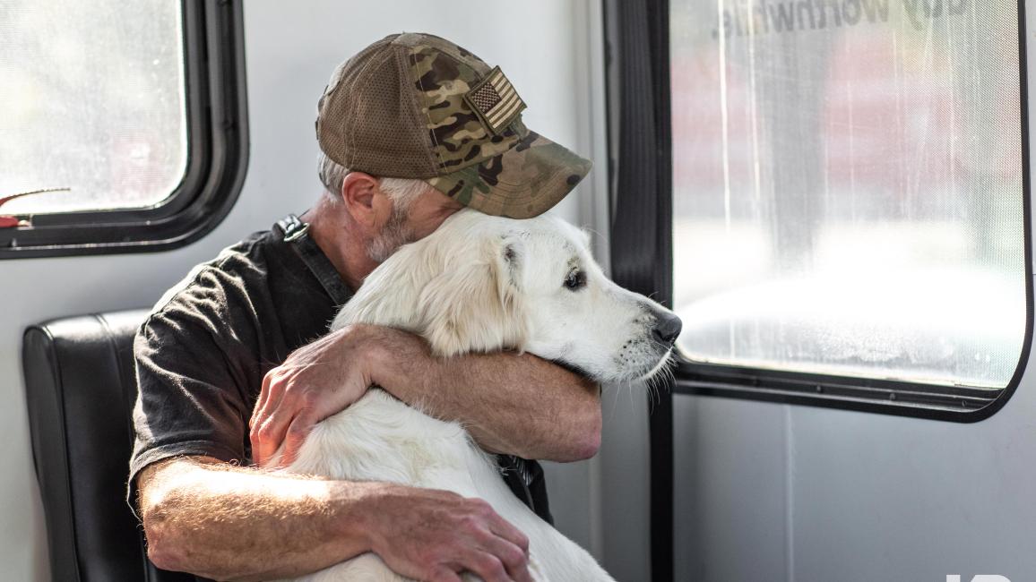 Veteran hugging his dog courtesy of K9s for Warriors