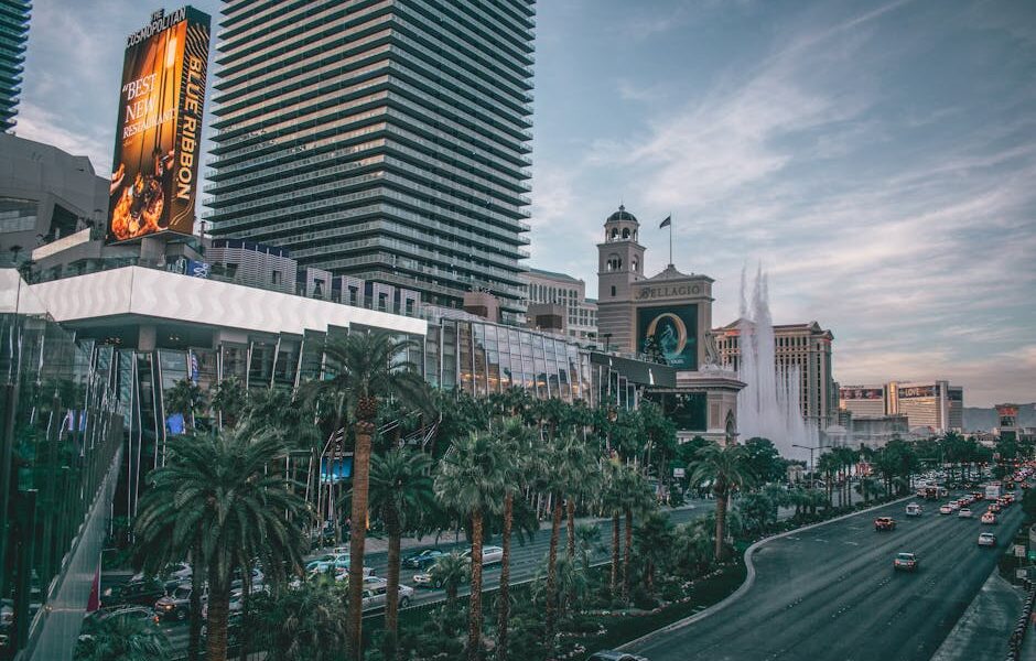 Vibrant view of Las Vegas's iconic skyline and busy boulevard with modern buildings and neon lights.