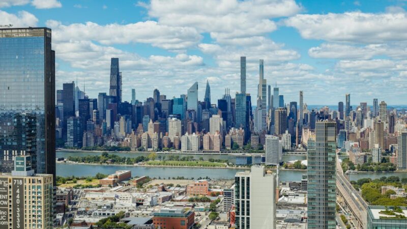 Explore the stunning New York City skyline with a clear view of iconic skyscrapers under a vibrant sky.