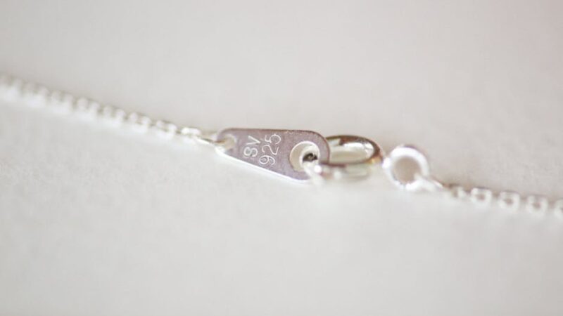Detailed view of a sterling silver clasp on a necklace chain.